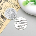 Macro detail of round antique silver alloy pendant with engraved inspirational quote for DIY - Give a Girl (8317)