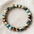 Bracciale di perle artistiche con pietre sintetiche marmorizzate in blu e arancione - Stile Pietra con Texture Dipinta (ZJ16017)