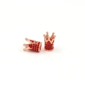 Macro view of two rose gold crown beads with red rhinestones for DIY jewelry making - Rose Gold With Red Zirconia