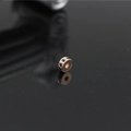 Macro shot of rose gold spacer bead with black rhinestones on a reflective black background - Rose Gold Black