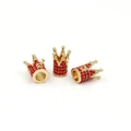 Detailed view of three golden crown-shaped beads with red rhinestones for jewelry making - Gold Red Zircon
