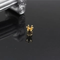 Golden crown jewelry charm with black micro-pave stones on reflective background - Gold Black Zirconia