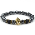 Detailed macro view of Spartan helmet charm with hematite and lava stone beads - Large Helmet / Antique Gold