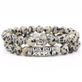 Detail of Dalmatian Jasper bead bracelet set with silver Buddha head and metal tube charms - Two-Piece Set / Spotted Stone
