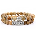 Macro shot of stone beaded bracelet set featuring silver Buddha head and engraved metal tube - Two-Piece Set / Picture Jasper