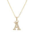 Close-up of golden letter A pendant with crown design and shimmering zircon stones - Letter A / Gold