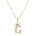 Close-up of golden letter G pendant with crown and micro-paved sparkling zircon stones - Letter G / Gold