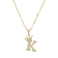 Close-up of golden crown initial K necklace with micro-pave sparkling zircon stones - Letter K / Gold