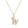 Close-up of golden letter W pendant with micro-paved zircon crown on delicate chain - Letter W / Gold