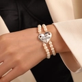 Set of two Best Friends pearl bracelets with silver heart pendants on a model's wrist - Artificial Pearl Heart Best Friends Splice Pendant Style (ZJ6737)