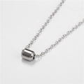 Macro shot of minimalist solid cylindrical pendant in polished silver stainless steel - Cylinder Style (ZJ4074)