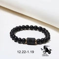 Detail of matte black onyx Capricorn bracelet with gold spacers and zodiac symbol cylinder - Capricorn (ZJ4605)