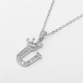 Macro shot of silver crown letter U necklace with sparkling cubic zirconia pavé setting - Letter U / Silver
