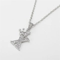 Detailed macro view of silver crown letter X pendant with micro-pave cubic zirconia crystals - Letter X / Silver