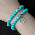Detail of 8mm turquoise beaded bracelet set with silver Tree of Life charm on a wrist - Tree of Life Turquoise Style (ZJ12918)