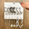 Set of 7 silver earrings with pearls, hearts, and butterfly motifs on wood background - 9 Pairs Set-Silver Butterfly Heart Pearl