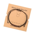 Detail of handmade Taurus Morse code bracelet with wooden beads on kraft card - Taurus