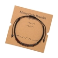 Detail of Aquarius Morse code bracelet with wood beads and black cord on a display card - Aquarius