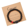 Detail of Cancer zodiac beaded bracelet with matte black beads on a thematic kraft card - Cancer (ZJ9622)