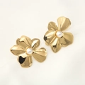 Elegant gold flower earrings with white pearls for women on white textured fabric background - Gold