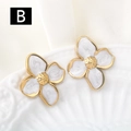 Detailed macro view of gold flower earrings with white enamel marble texture - White and Gold (B)