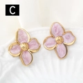 Macro view of pink marble flower earrings with gold finish on white ceramic plate - Pink Marble(C)