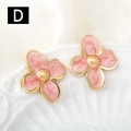 Detailed close-up of pink enamel flower earrings with golden edges on white ceramic - Coral Pink (D)