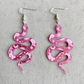 Bohemian pink translucent snake earrings with celestial floral patterns on stone surface - Pink