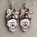 Close-up of wooden skull earrings with messy bun and baseball pattern on stone background - Wood Red Baseball Messy Bun Skull