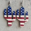 Close-up of cactus-shaped wooden earrings featuring an American flag pattern and silver hooks - Flag Cactus Style