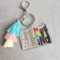 Macro detail of BE KIND acrylic keychain with rainbow victory hand and colorful tassel - Transparent Rainbow Print Multicolor Tassel (1)