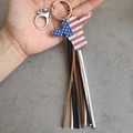 Detail of western bull skull keychain with American flag pattern and leather tassels - Bull Head Flag Style