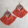 Detail of bohemian wood geometric drop earrings with dense rust red woven tassels - Caramel color