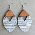 Detail of bohemian wooden drop earrings with blue ethnic patterns on cement background - Geometric Texture (1)