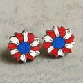 Macro shot of wooden sunflower studs featuring American flag colors on a rustic base - Sunflower Style