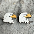 Rustic wooden eagle stud earrings with detailed bald eagle print on stone surface - Eagle Style