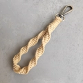 Detail of bohemian handmade braided cotton rope wristlet with retro bronze metal clasp - Spiral Braid Style / Natural Wood Color