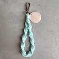 Close-up of mint green macrame keychain with wooden tag and bronze lobster clasp - Spiral Woven Style (With Wood Tag) / Mint Green