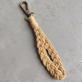 Close-up of bohemian hand-woven cotton rope keychain with bronze clasp detail - Basic Style / Beige