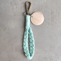 Detail of mint green braided cotton keychain with bronze lobster clasp and round wood tag - With Wood Tag / Mint Green
