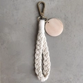 Detail of macrame keychain featuring off-white braided rope and round wooden tag - With Wood Tag / Off White