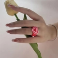 Y2K style red resin ring with layered pink hearts shown on finger with tulip - Red Base Pink Heart Style(ZJ8105)