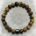 Macro shot of 8mm tiger eye stone beads bracelet with black cylindrical metal charm - Yellowish Brown Tiger Eye Style (ZJ9853)