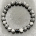 Macro view of 8mm gray marble stone beads and polished black cylinder bead on men's bracelet - Grey Marble Jasper Style (ZJ9854)