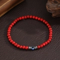 Rode turkooizen kralenarmband met blauwe evil eye bedel en zilveren afstandhouders - Rode Turkoois