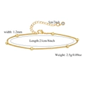 Detail view of gold bead anklet with lobster clasp, extender chain and zircon charm - 1.2mm Satellite Chain (ZJ10852)