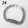 Macro detail of silver stainless steel chain bracelet with floral engraved S logo plate - Standard Length / Vintage Relievo Vine Style
