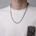 Close-up of gunmetal grey Figaro chain necklace worn over a white casual sweatshirt - 55cm / Dark Gray