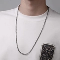 Close-up of long silver Figaro chain necklace styled on a male model with white sweatshirt - 70cm / Dark Gray