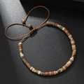 Adjustable natural stone beaded bracelet with earth tones and braided rope on black background - Earth Tone Natural Stone Beaded Bracelet (ZJ12538)